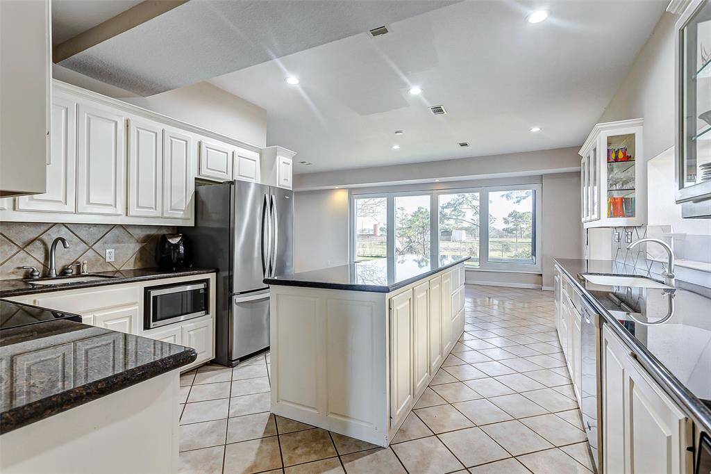 The kitchen features dual sinks, stainless steel appliances and stunning views from oversized windows.