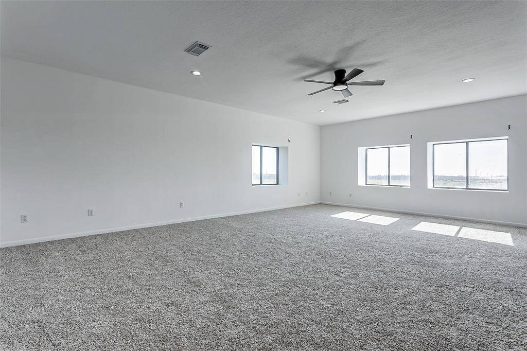 The expansive second-floor primary suite features abundant natural light through double-exposure windows. Newly updated with fresh carpet and paint, it offers a spacious canvas to design your perfect retreat.