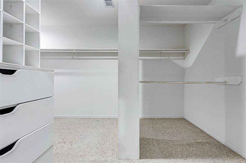 Expansive walk-in closet with custom built-in storage.