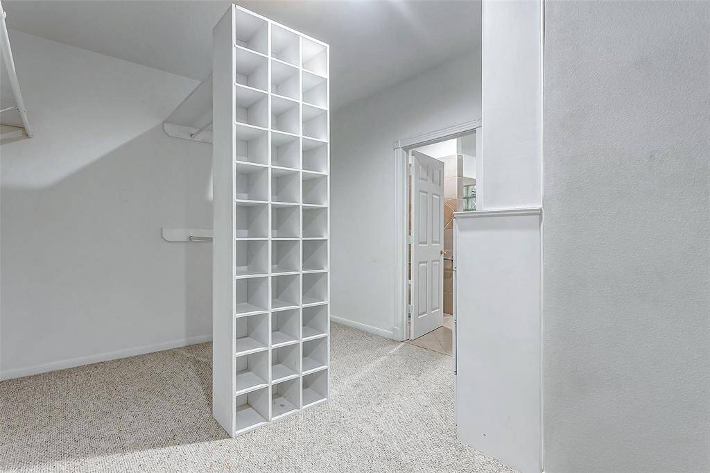 Expansive walk-in closet with custom built-in storage.