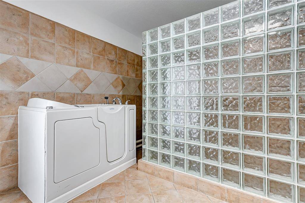 Explore the second primary ensuite with walk-in soaking tub and separate shower.
