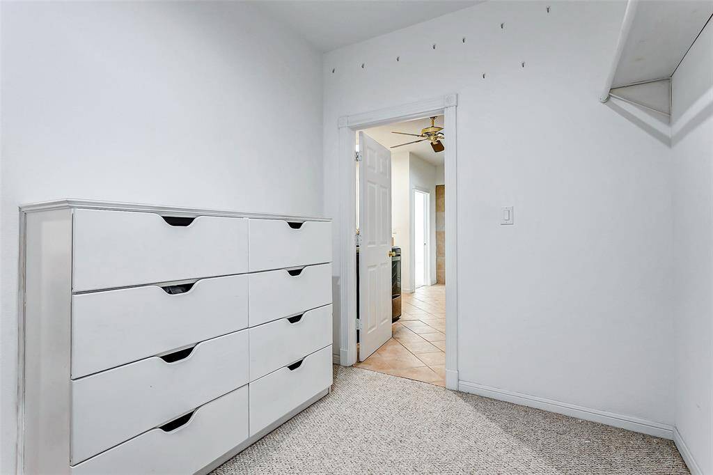 Spacious walk-in closet with built-in drawers.