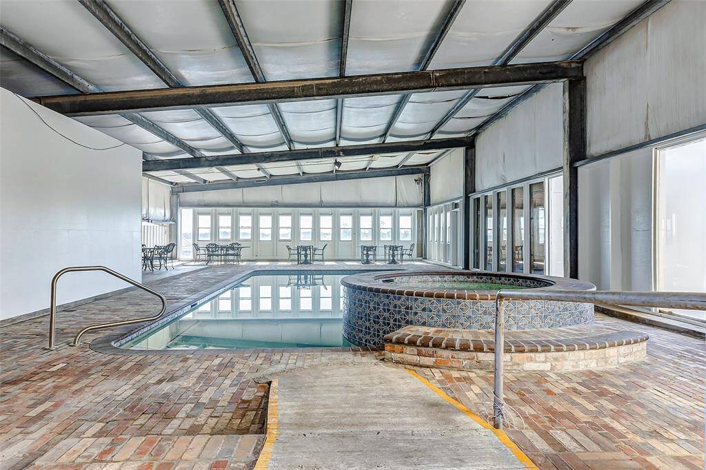 Indoor pool and spa seamlessly connected to the main residence, enhanced by abundant natural light.