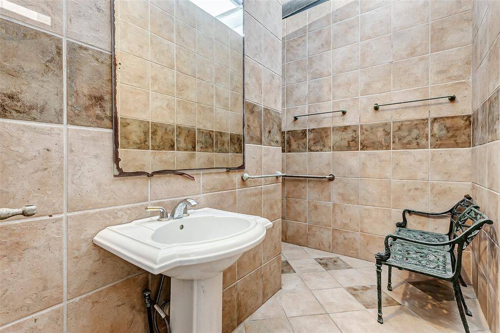Pool house includes a convenient half bath and shower.