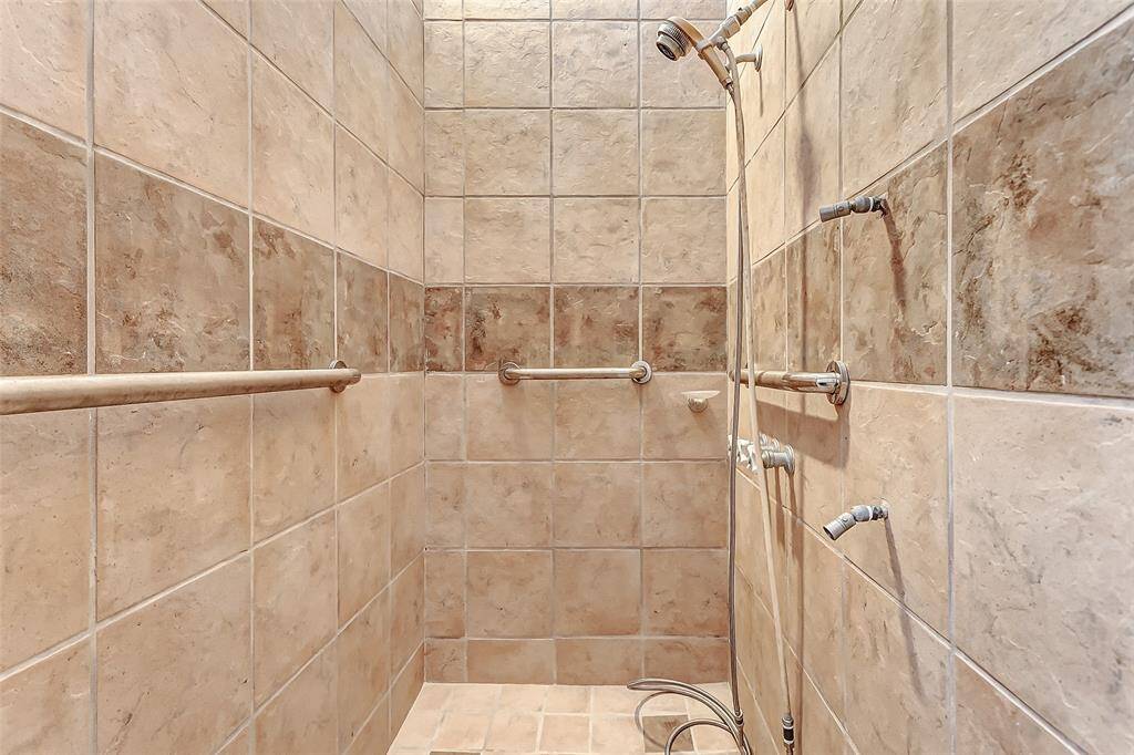 Poolside shower with elegant tile design.