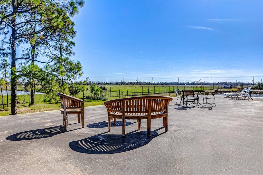 A spacious 1,612 sq. ft. patio extends from the pool house, offering scenic views.
