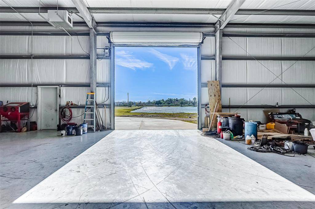 Large automatic garage door revealing a scenic property view.