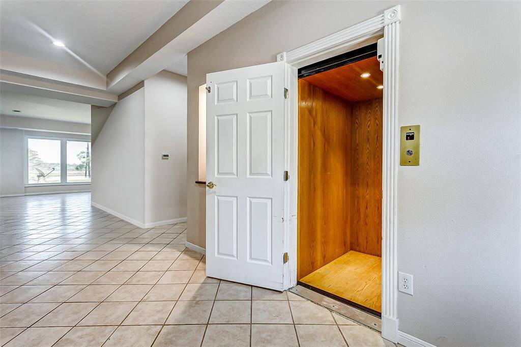 Conveniently located just off the main entry, this home features a private elevator, offering accessibility and convenience.