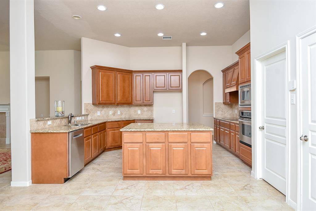 The timeless benefits and beauty of the open floor plan design concept are clearly seen here, with open travel between living and kitchen common areas.