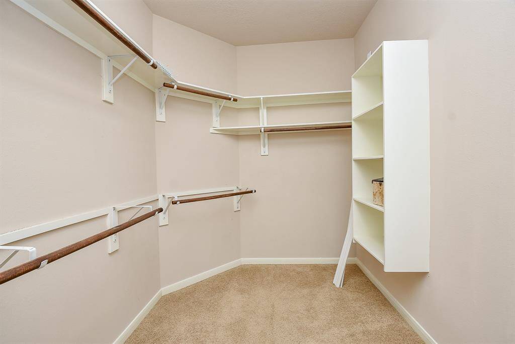 There's amazing storage and organization in your huge carpeted primary walk-in closet.