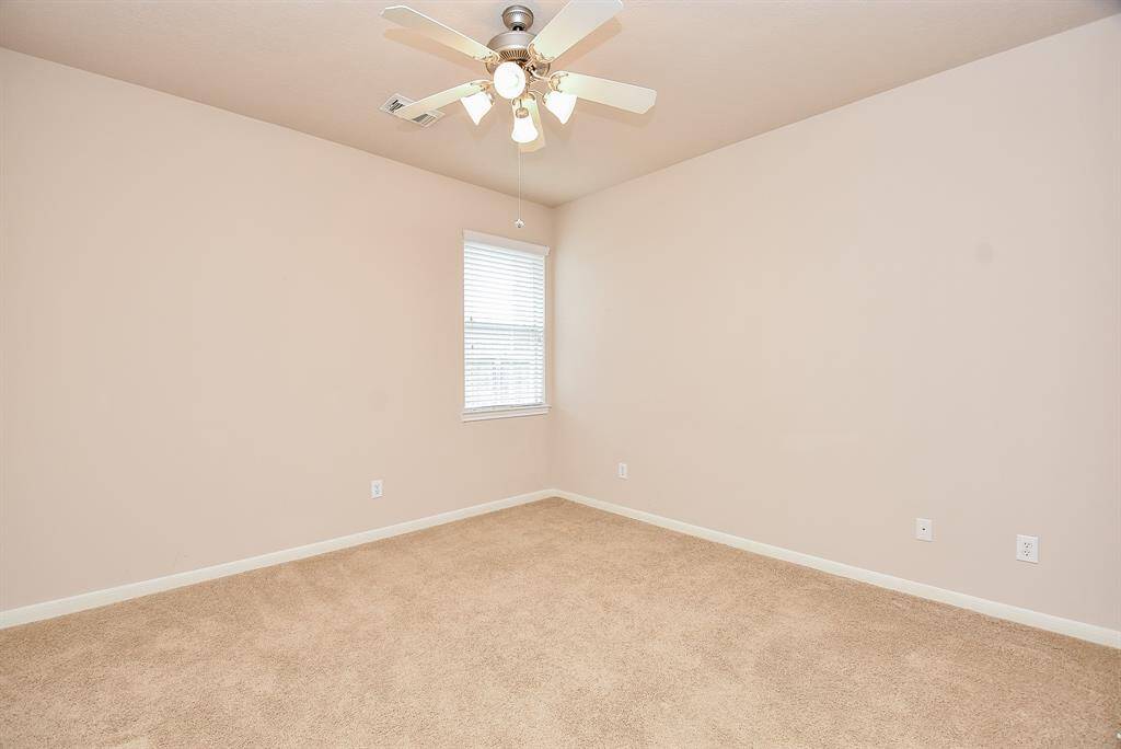A corner window provides more floor/wall space in this secondary bedroom.