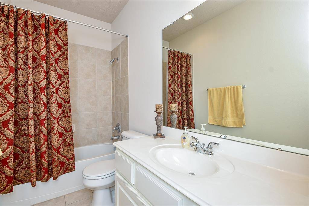 Another secondary bath offers the comfort and convenience of combined shower/bathtub.