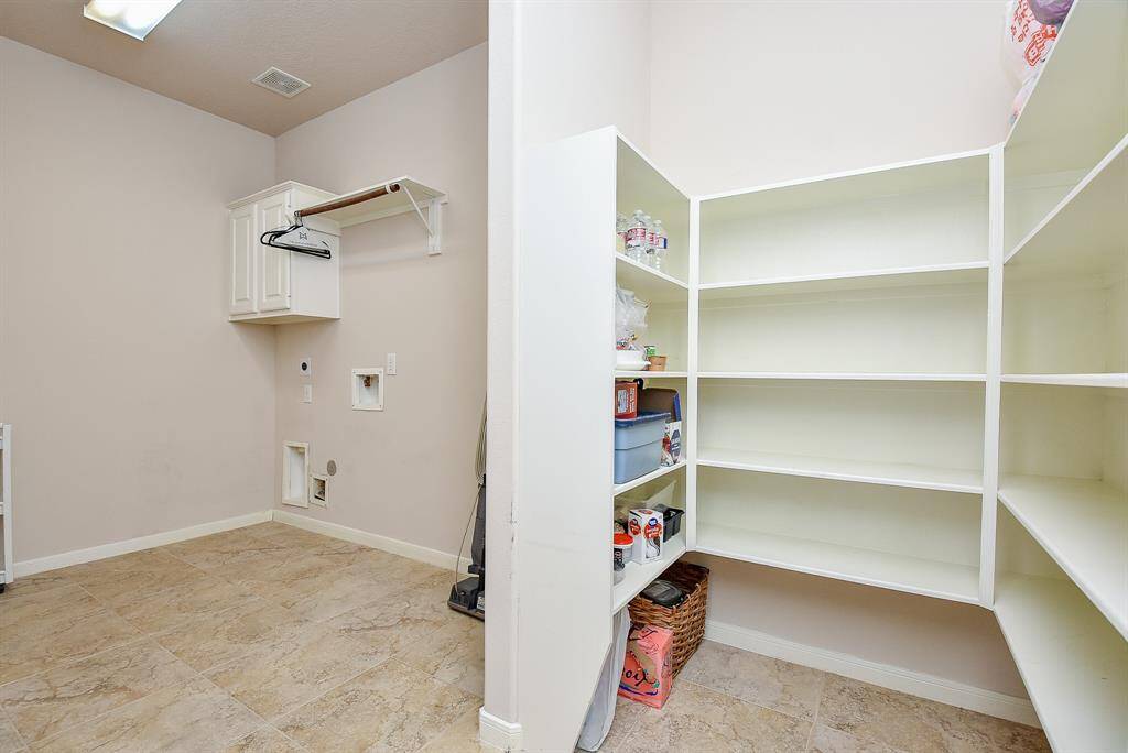 This amazing utility/storage room makes laundry day and organizing household materials, a breeze.