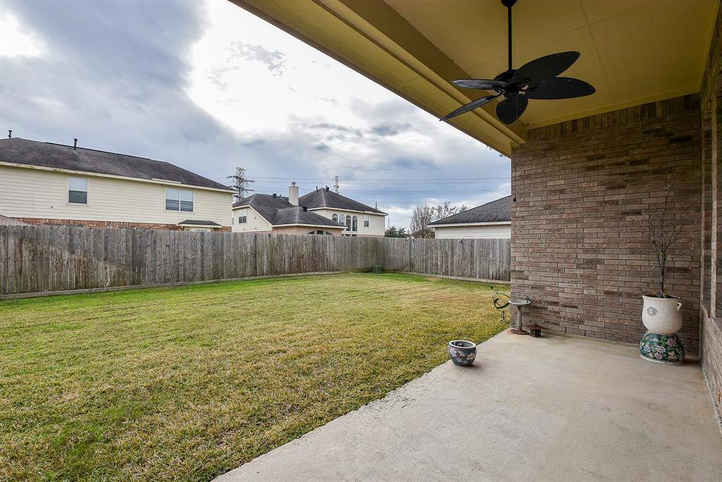Wow! Your entire rear property is lined with privacy fencing, as seen from the brick lined covered patio.