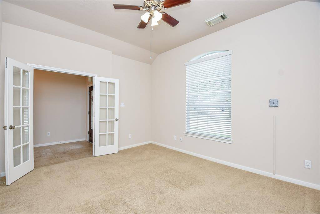 This special front carpeted room offers high ceiling, great natural light, classic french doors suggesting privacy, if desired, and space galore as a home office/study, perhaps.