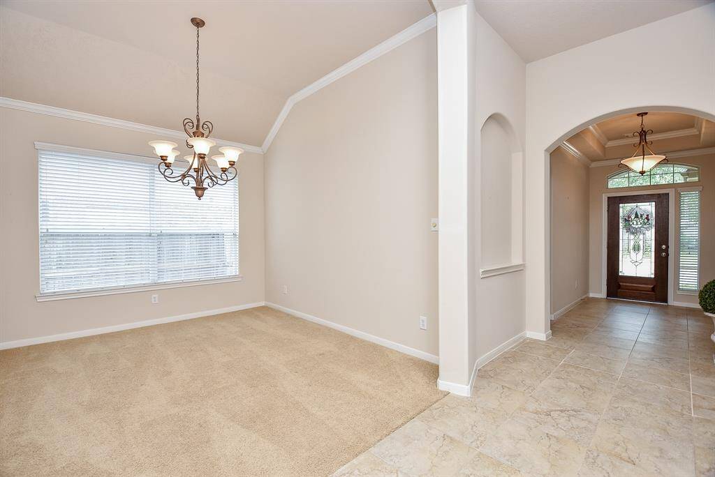 This is a great view, showing perspective from front entry to your lush dining area, left.