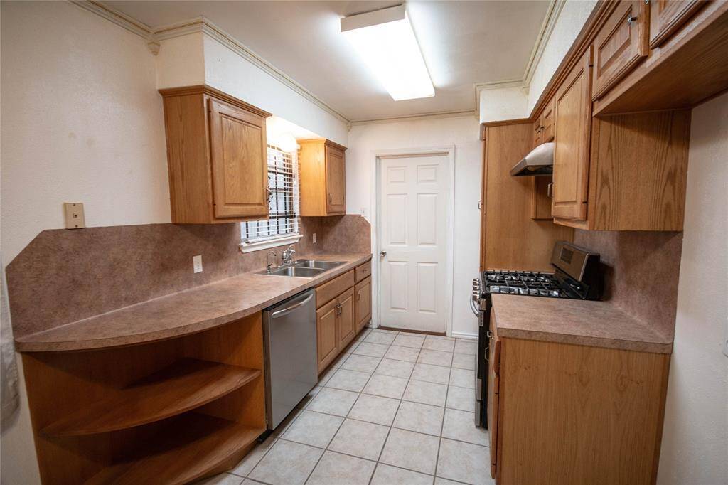 Modernized kitchen with sleek finishes and updated appliances.