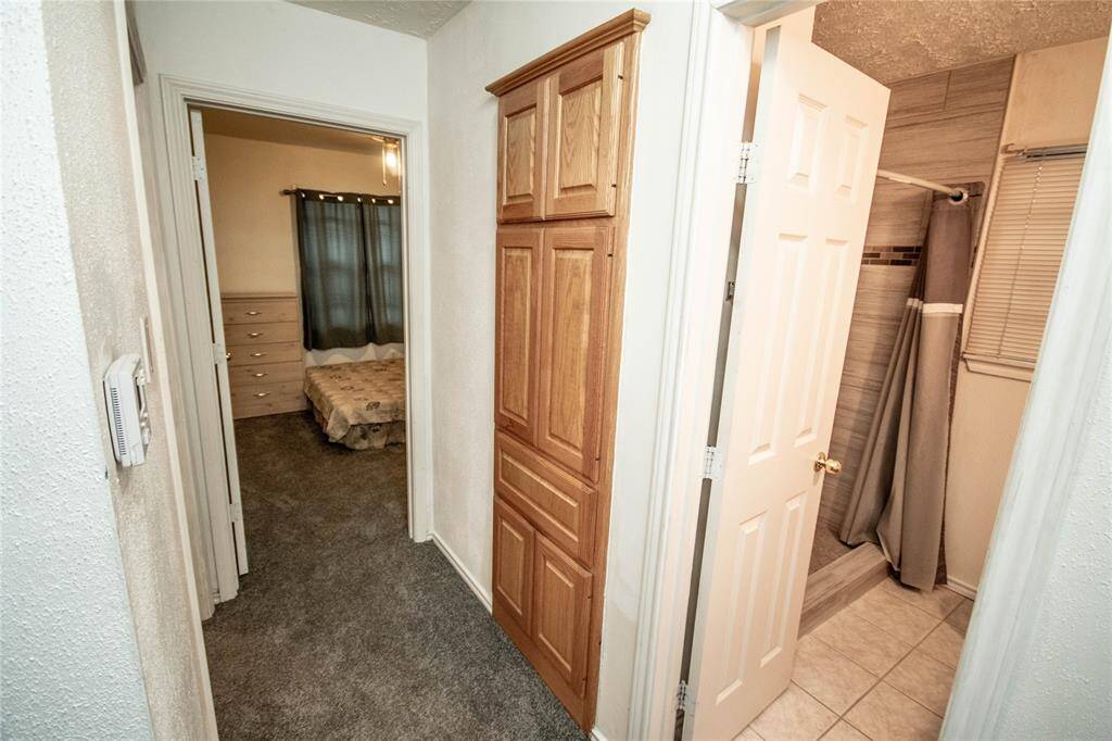 Hallway leading to cozy bedrooms and a stylish bathroom.