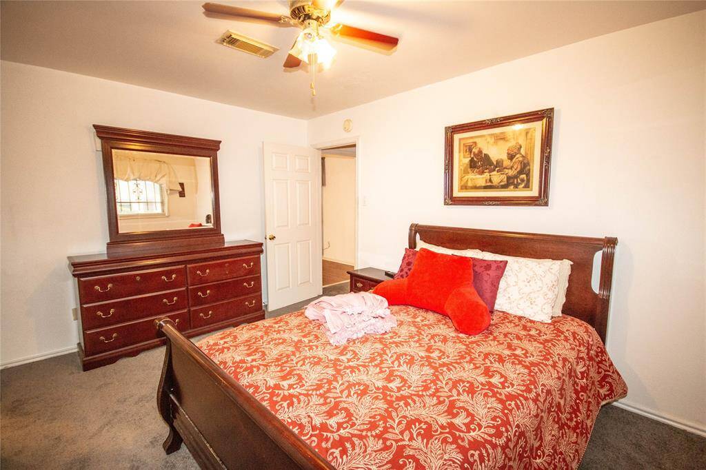 The primary bedroom offers a cozy retreat with warm tones, elegant furniture, and ample natural light.