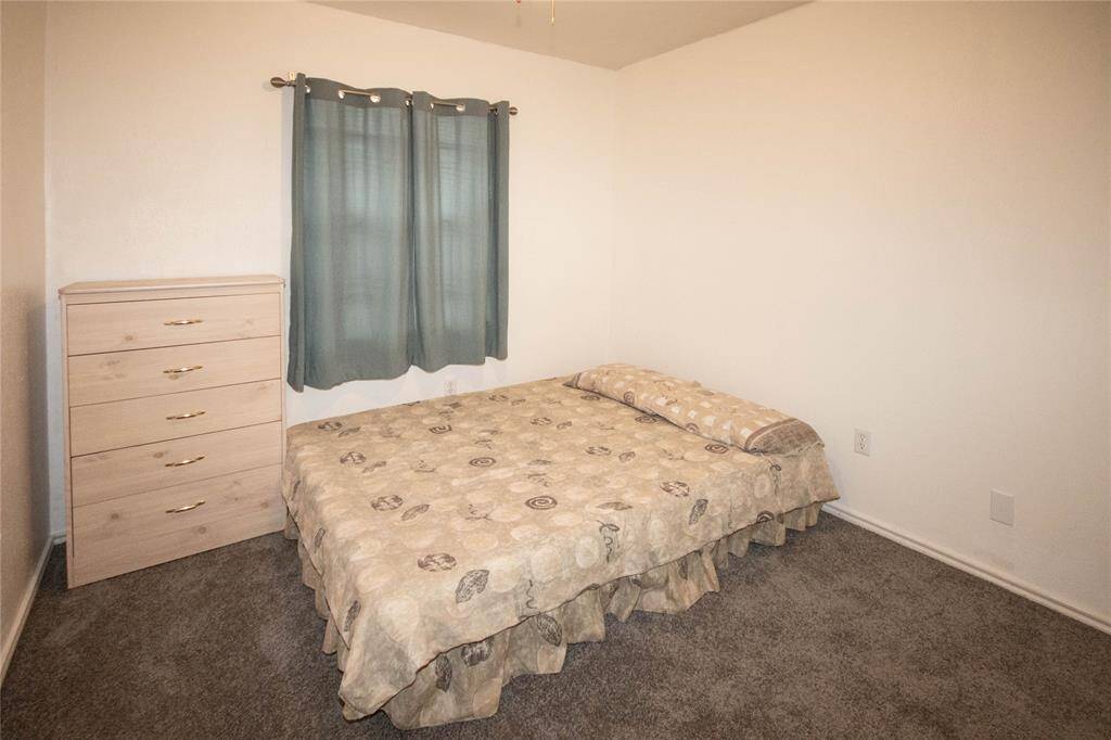 Cozy third bedroom featuring soft carpeting and ample natural light, perfect for guests or a home office.
