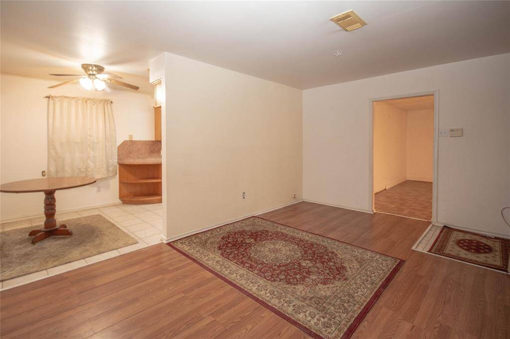Discover a cozy living space with warm hardwood floors and a versatile layout, perfect for relaxation and entertaining.