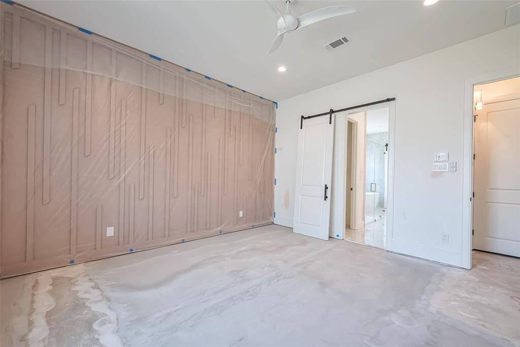 Elegant primary bedroom with wall paneling. Photos as of 03/20/2025.