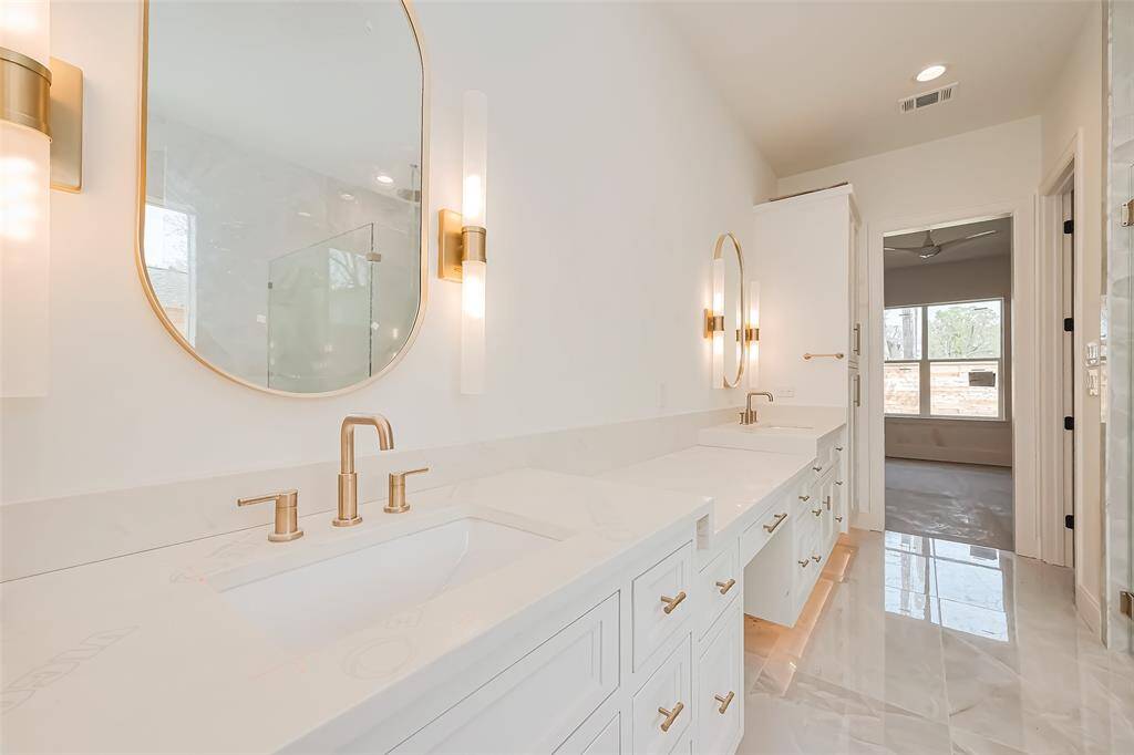 Primary Bathroom Lavish floor-to-ceiling tile for a spa-like ambiance. Photos as of 03/20/2025.