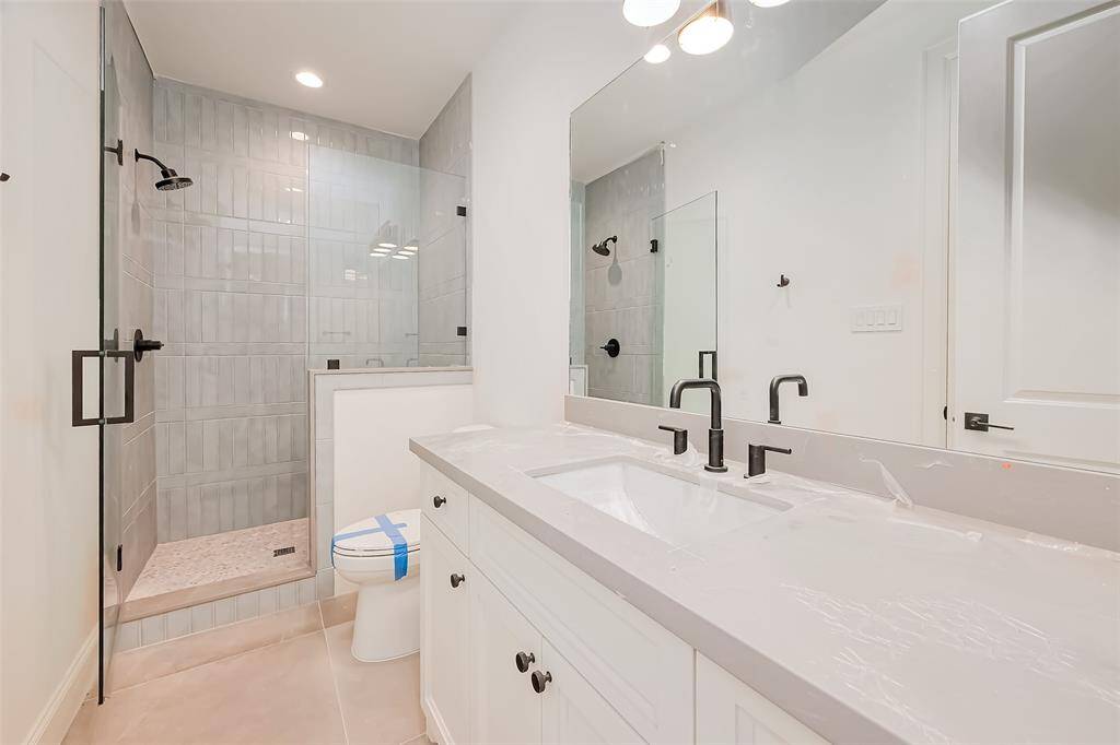 Secondary Bathroom Designer floor-to-ceiling tile with a modern aesthetic. Photos as of 03/20/2025.