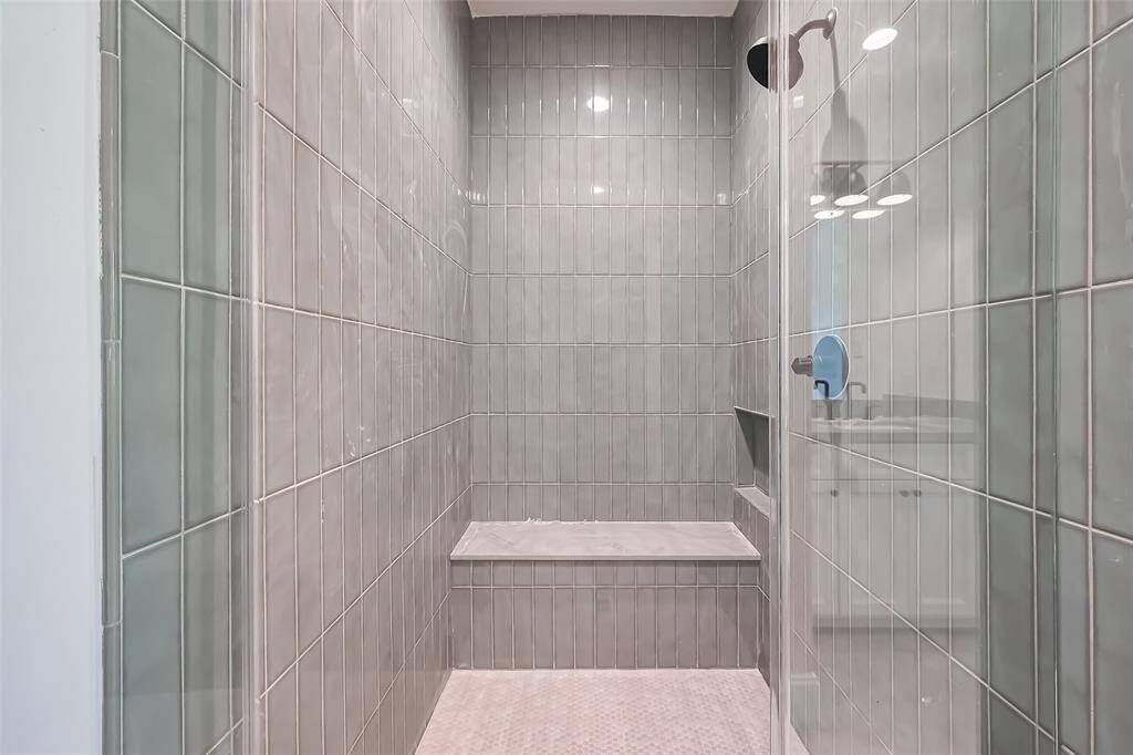 Secondary Bathroom Designer floor-to-ceiling tile with a modern aesthetic. Photos as of 03/20/2025.