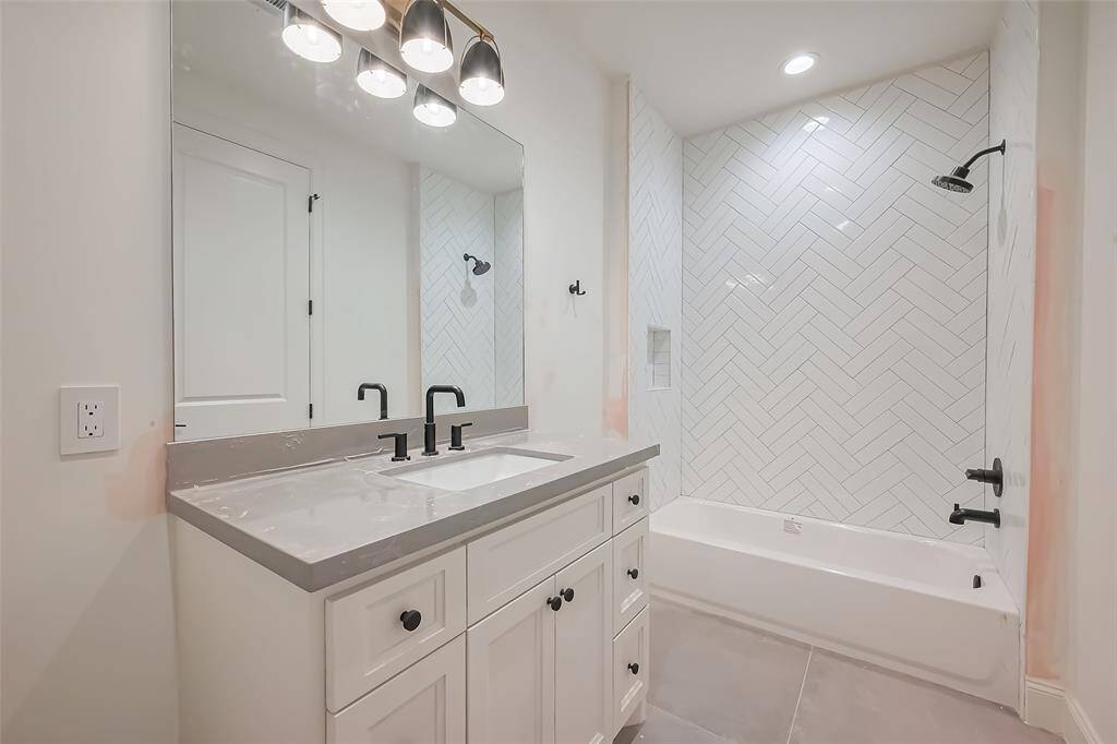 Secondary Bathroom Designer floor-to-ceiling tile with a modern aesthetic. Photos as of 03/20/2025.