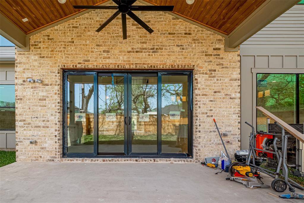Stunning covered back porch showcasing exceptional architectural design. Photos as of 03/20/2025.