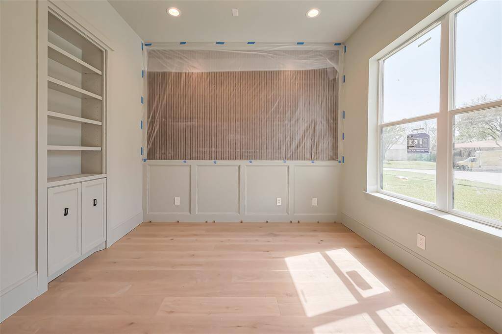 Stylish home office with custom wall paneling. Photos as of 03/20/2025