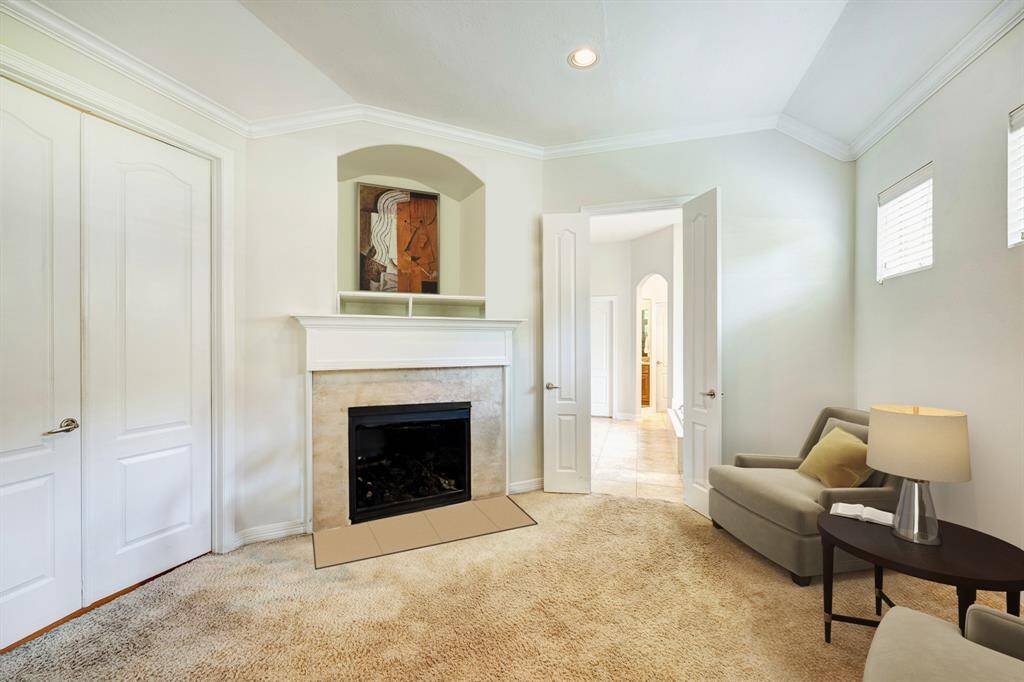 Additional view of the primary seating area. Double doors lead to the bath and closets. Photo is virtually furnished.