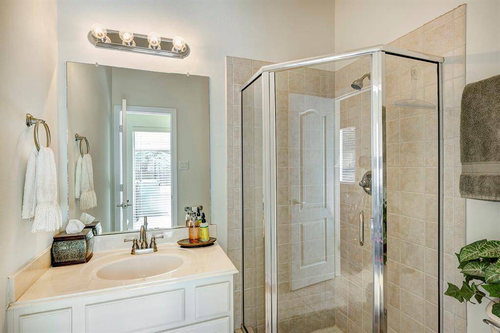 A full bath with glass enclosed shower is next to the flex room on the first floor.