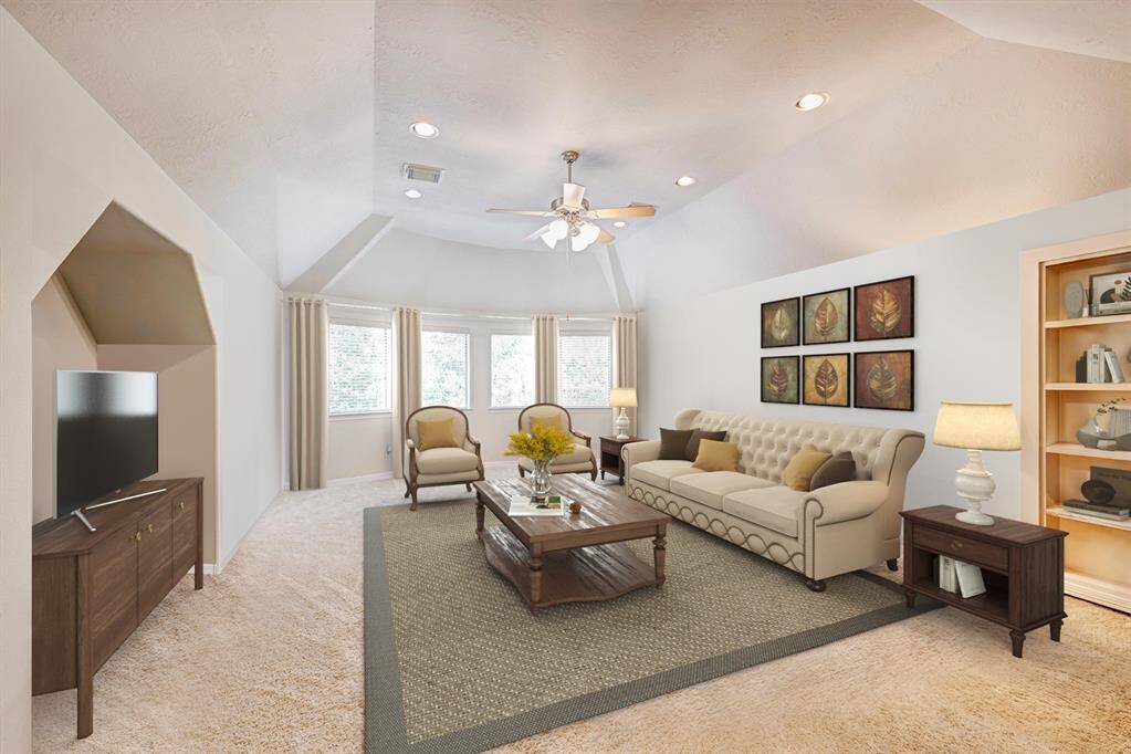 Located at the top of the stairs is the game room. Plenty of space for cozy movie nights, a pool table, or whatever you desire! A hidden room is behind the bookcase. Photo is virtually furnished.