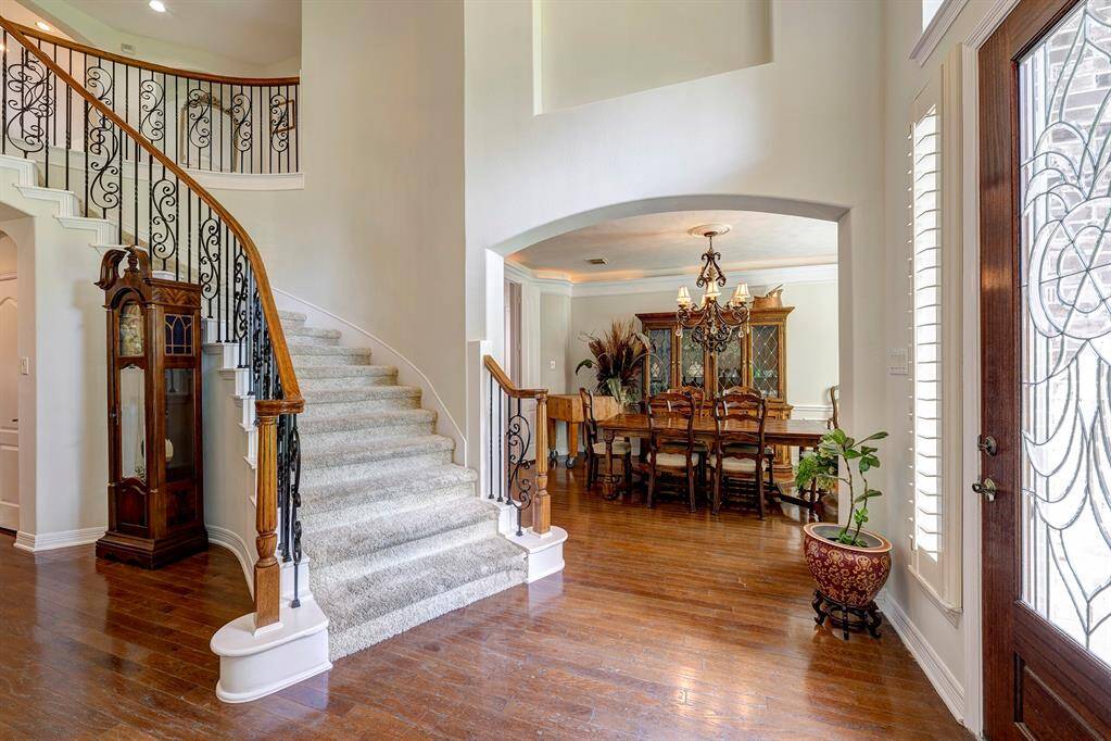 Step inside to a grand two story foyer with curved staircase, art niches, and wood floors.