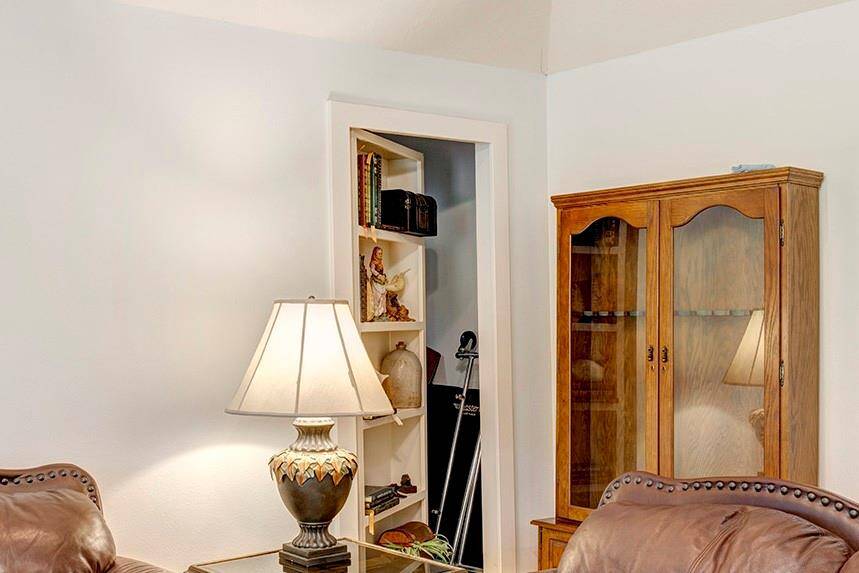 The bookcase reveals a hidden room - perfect for holiday storage, luggage, or valuables.