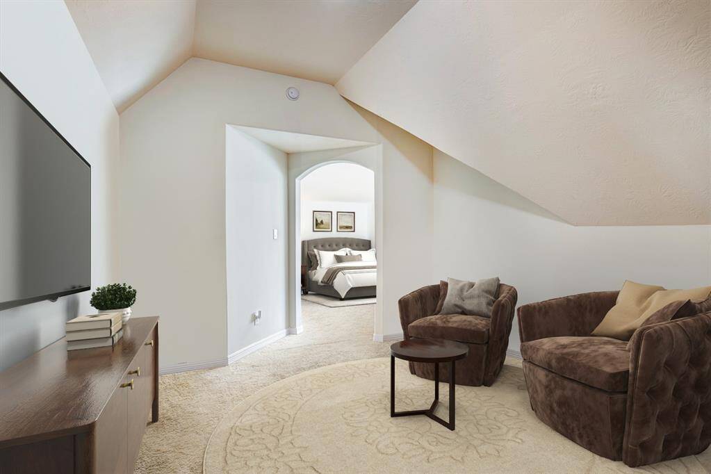 The second floor primary suite features a living area, private bath, and two closets. Photo is virtually furnished.