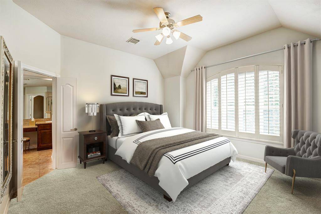 Second floor primary bedroom with views to the front yard. Photo is virtually furnished.