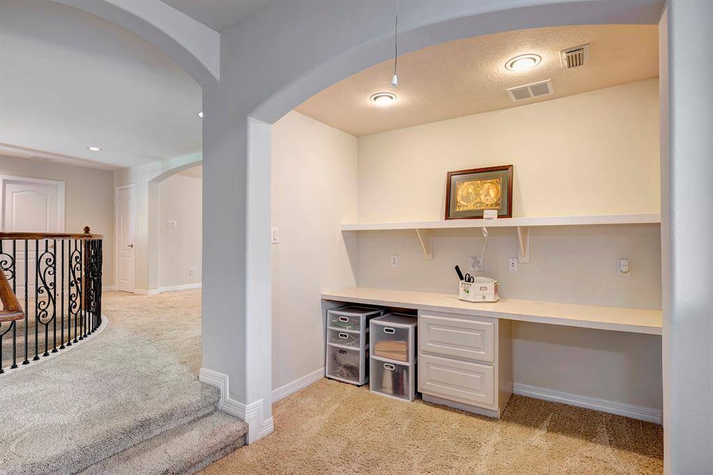 A study or craft nook is conveniently located near the back staircase. A laundry chute is nearby.