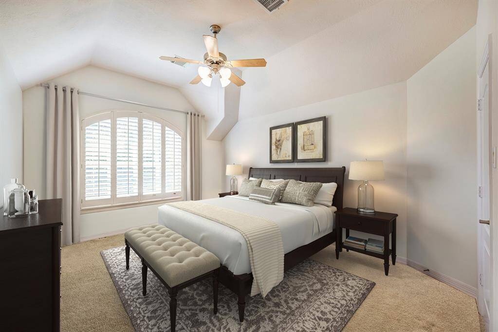 One of three secondary bedroom suites upstairs. Each with their own private bath and walk-in closet. Photo is virtually furnished.