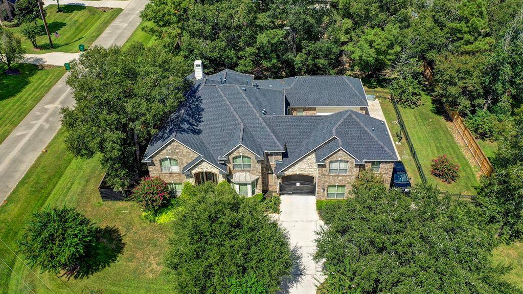 This property includes a gated drive, four car garage, porte-cochere, and additional parking.