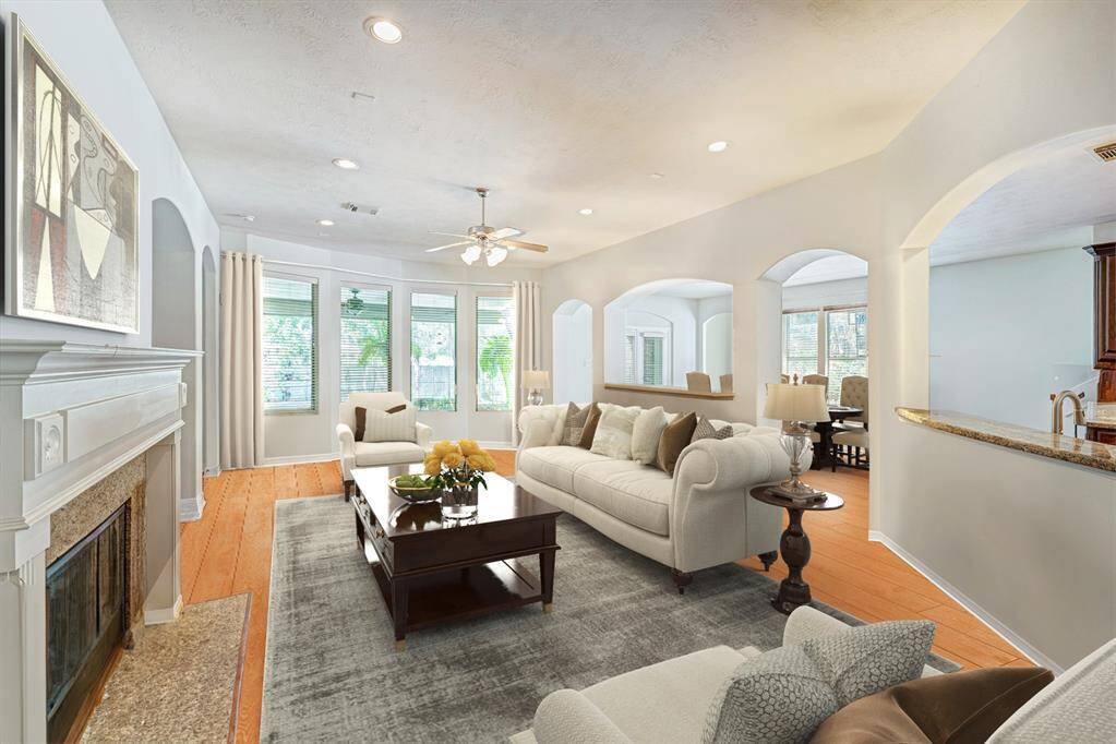 The family room easily accommodates a crowd with multiple seating areas. Photo is virtually furnished.
