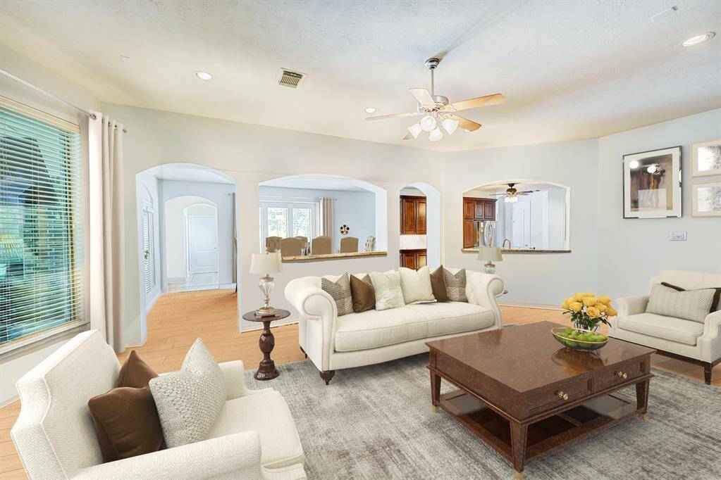 The family room is open to the breakfast area, kitchen, and looks onto the covered patio. Photo is virtually furnished.