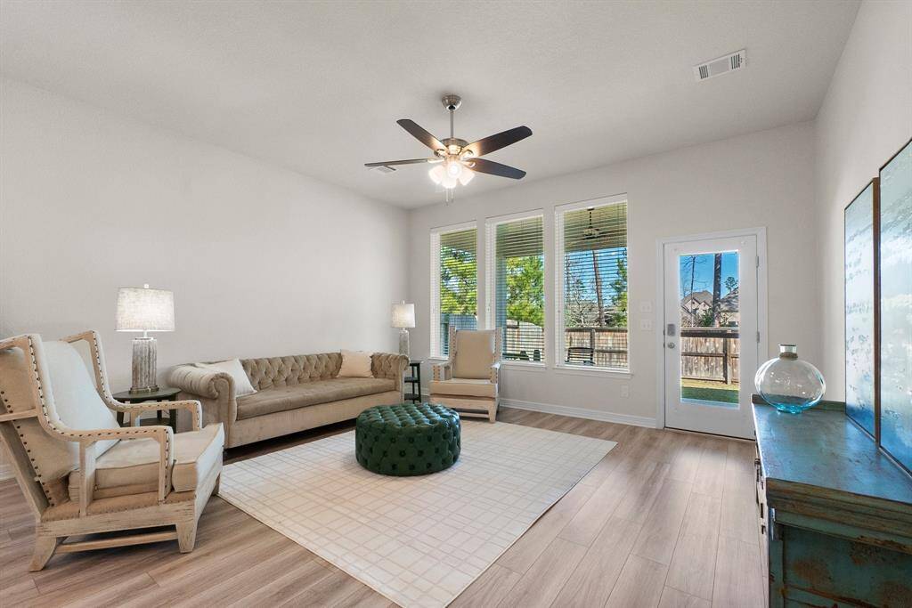 10 foot ceilings and oversized windows overlooking the covered patio and backyard