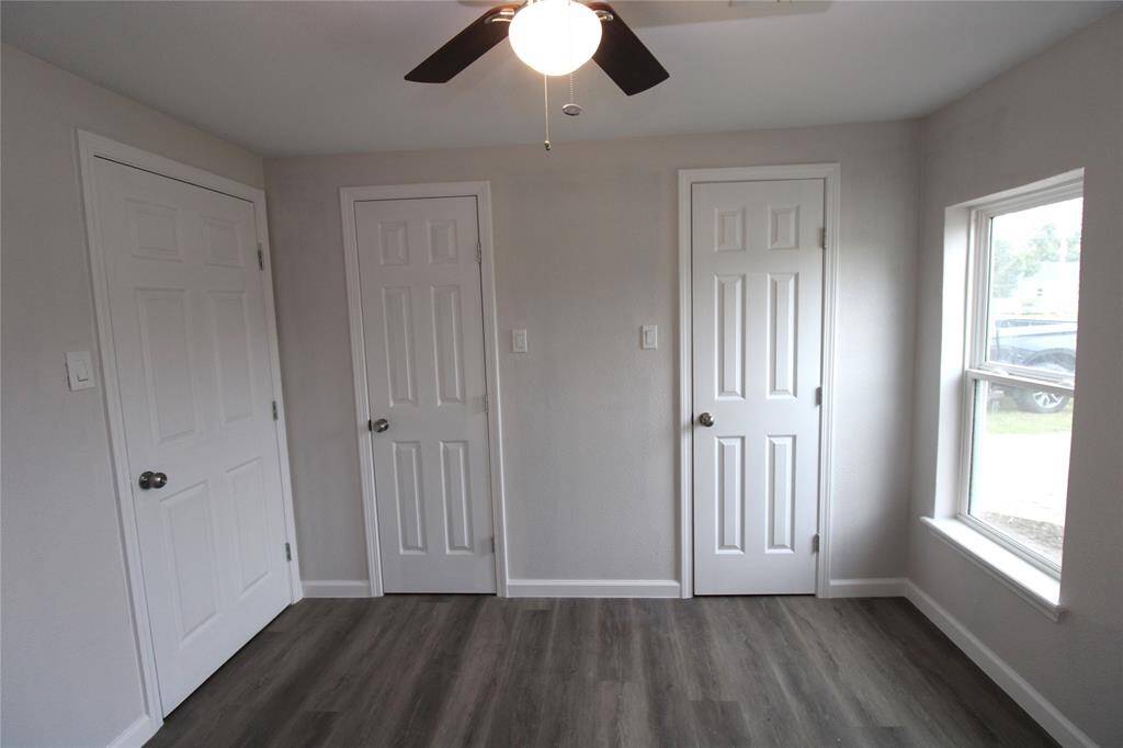 Primary room with double closets and large windows offers natural light.