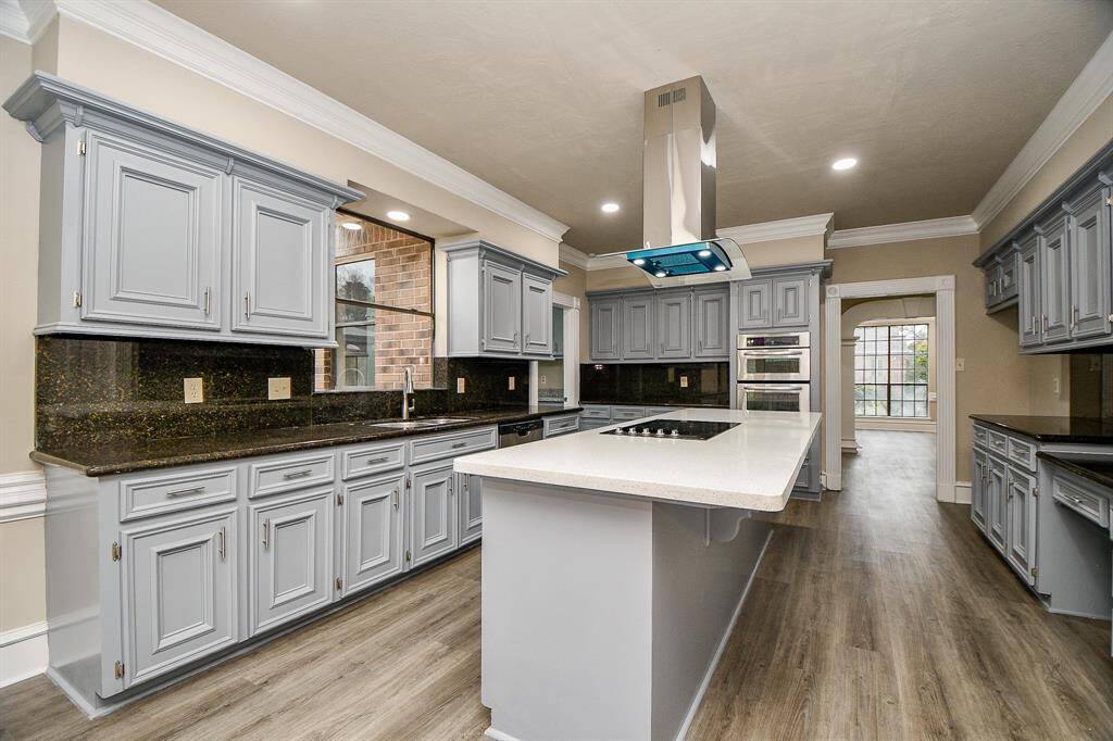 This perspective showcases the kitchen's unique layout and location of the large walk in pantry!  Also revealing a second staircase that goes up to the gameroom loft!  Talk about cozy, fun and convenience all wrapped up in one!