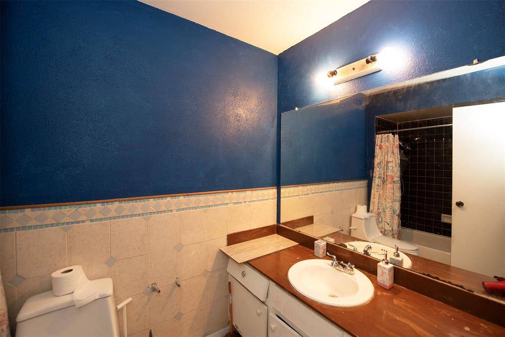 Additional bathroom with granite vanity and combo bathroom and shower.