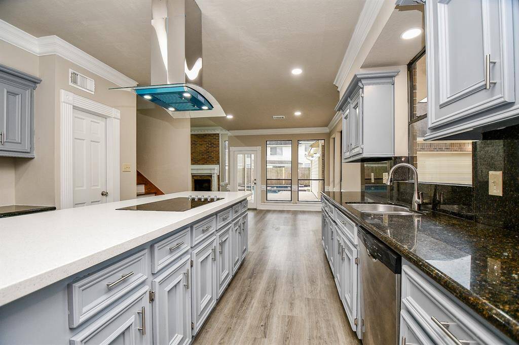 The aroma of freshly baked cookies fills the air in this inviting breakfast nook, creating a warm and welcoming atmosphere. From this cozy spot, you can admire the beautifully appointed kitchen on one side, the pool on the other and the elegant staircase leading to the upper levels!  Also, a glimpse into the comfortable living space just off the kitchen & back yard.