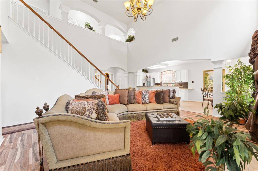 High ceiling living room overlooking the kitchen and dining area.